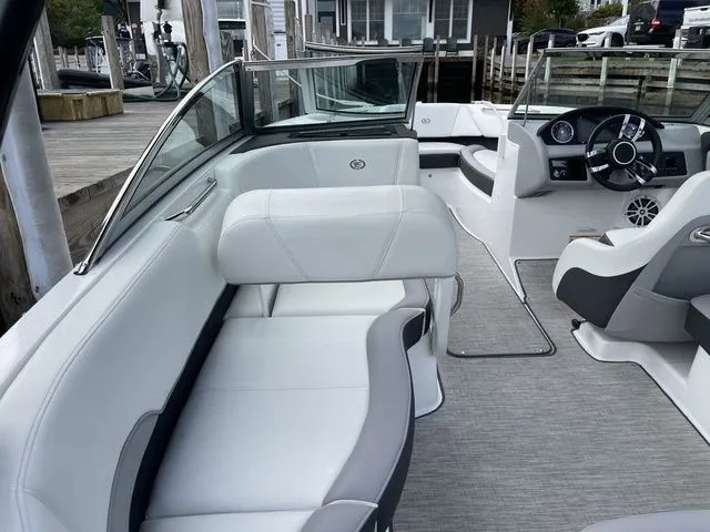Slide: The Image of 2024 Cobalt 220S boat interior with white seating and modern dashboard design. - 6