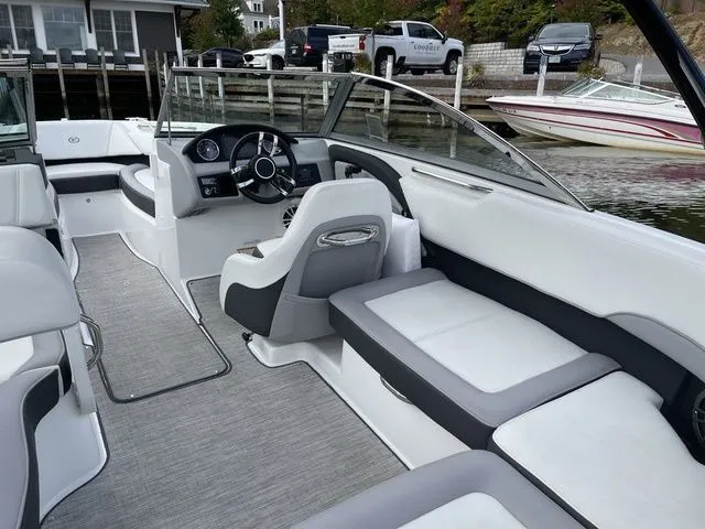Slide: The Image of 2024 Cobalt 220S boat interior with sleek seating and modern dashboard design. - 7