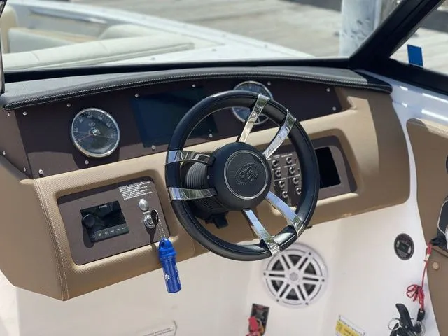 Slide: The Image of Steering wheel and dashboard of a 2022 Cobalt CS23 boat. - 9