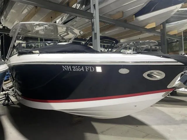 Slide: The Image of 2019 Cobalt R30 boat in storage, black hull with red stripe, registration NH 2554 FD. - 13