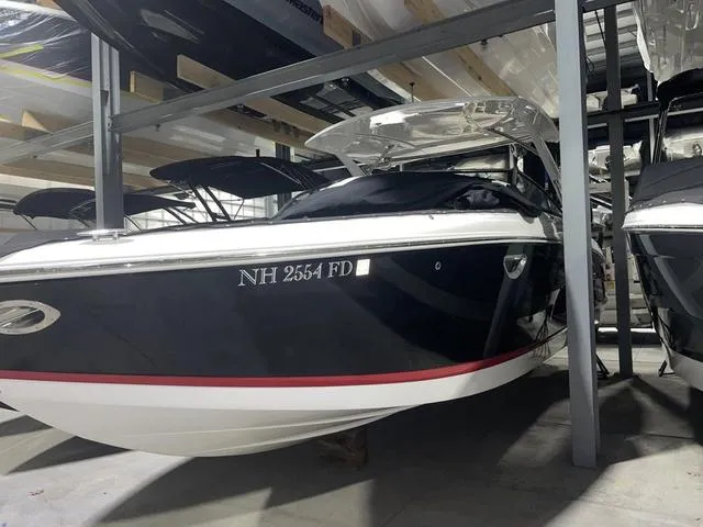 Slide: The Image of 2019 Cobalt R30 boat in storage, black hull with red stripe, NH registration. - 14