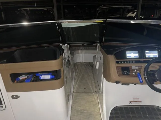 Slide: The Image of 2019 Cobalt R30 boat interior with dashboard and controls, featuring dual screens and storage compartments. - 22