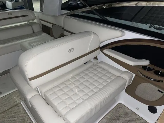 Slide: The Image of 2019 Cobalt R30 boat interior with white quilted seating and cup holders. - 23
