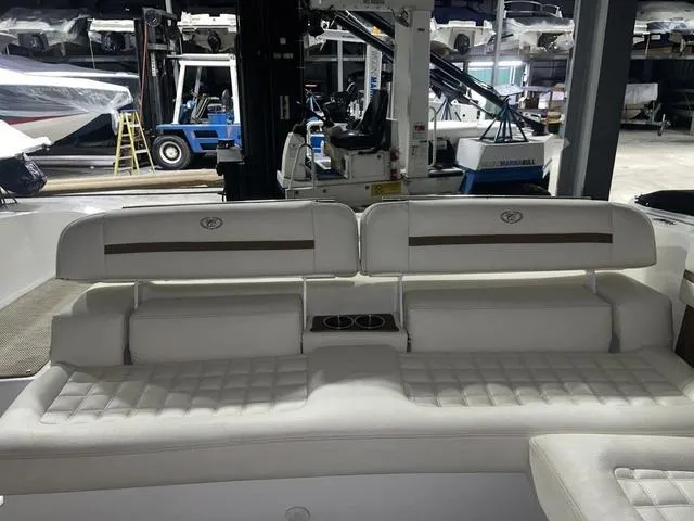 Slide: The Image of 2019 Cobalt R30 boat interior with white cushioned seating in a storage facility. - 24