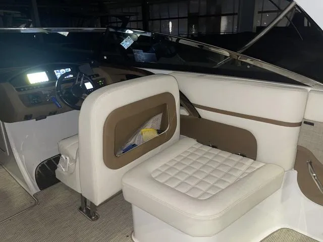 Slide: The Image of 2019 Cobalt R30 boat interior with white and brown seating, modern dashboard. - 26