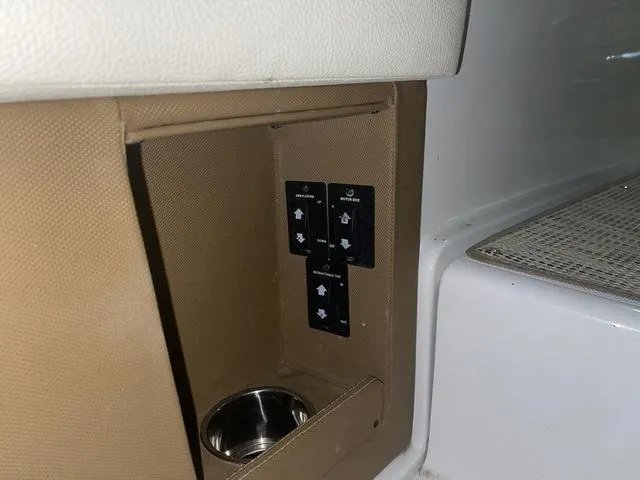 Slide: The Image of Control panel with cup holder in 2019 Cobalt R30 boat interior. - 30