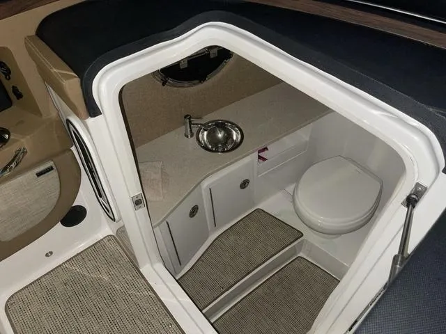 Slide: The Image of 2019 Cobalt R30 boat interior with compact bathroom, featuring a sink and toilet. - 33
