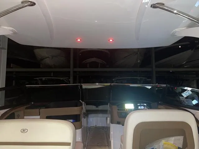 Slide: The Image of Interior view of a 2019 Cobalt R30 boat with illuminated dashboard. - 36