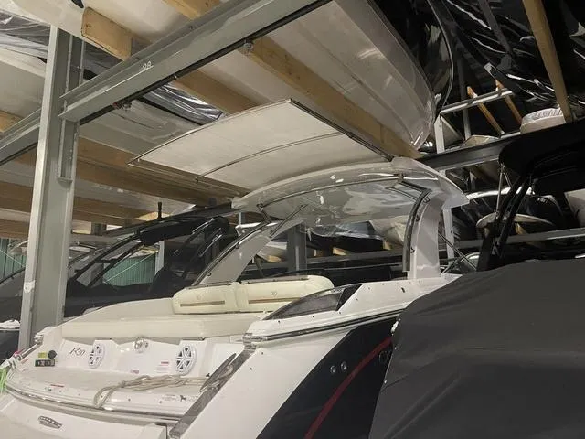 Slide: The Image of 2019 Cobalt R30 boat stored in a covered marina with other vessels. - 43