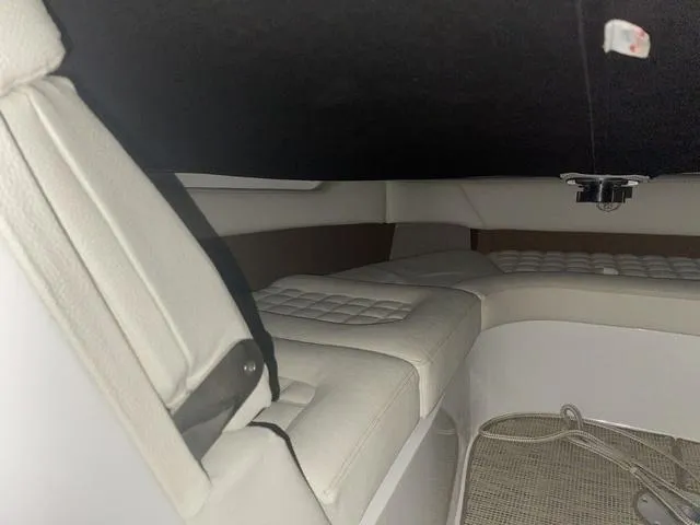 Slide: The Image of 2019 Cobalt R30 interior cabin with white cushioned seating and carpeted flooring. - 44
