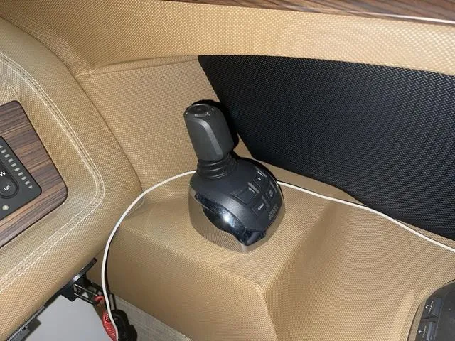 Slide: The Image of Joystick control in 2019 Cobalt R30 boat interior, featuring beige upholstery and wood accents. - 47