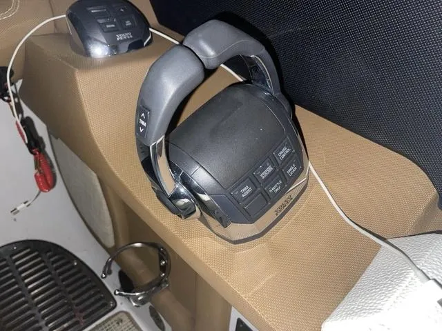 Slide: The Image of 2019 Cobalt R30 boat throttle control on brown dashboard. - 49