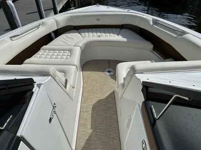 Slide: The Image of 2019 Cobalt R30 boat interior with white cushioned seating and beige flooring. - 7