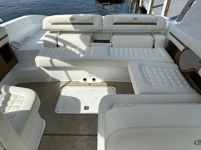 Slide: The Image of 2019 Cobalt R30 boat interior with white cushioned seating and water view. - 8