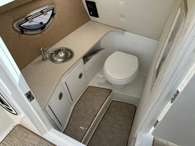 Slide: The Image of 2019 Cobalt R30 boat bathroom with sink, toilet, and storage cabinets. - 9