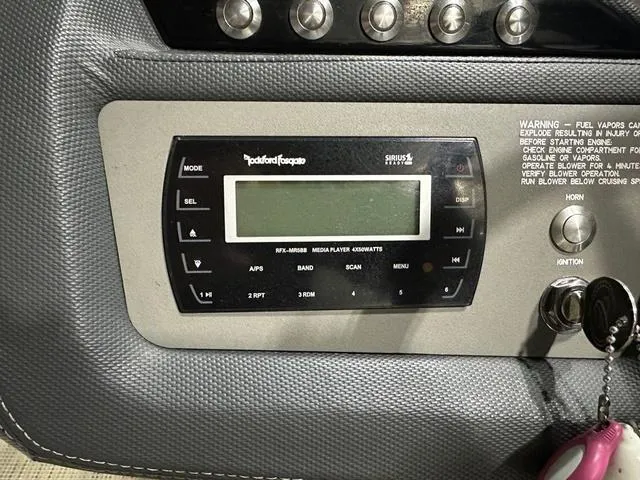 Slide: The Image of Control panel of a 2014 Cobalt R3 boat featuring a Rockford Fosgate media player. - 10