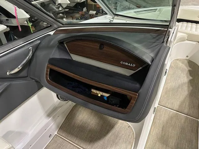 Slide: The Image of Interior of a 2014 Cobalt R3 boat, featuring a sleek glove compartment. - 7