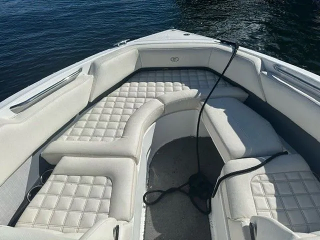 Slide: The Image of 2017 Cobalt R5 boat interior with white cushioned seating on calm water. - 10