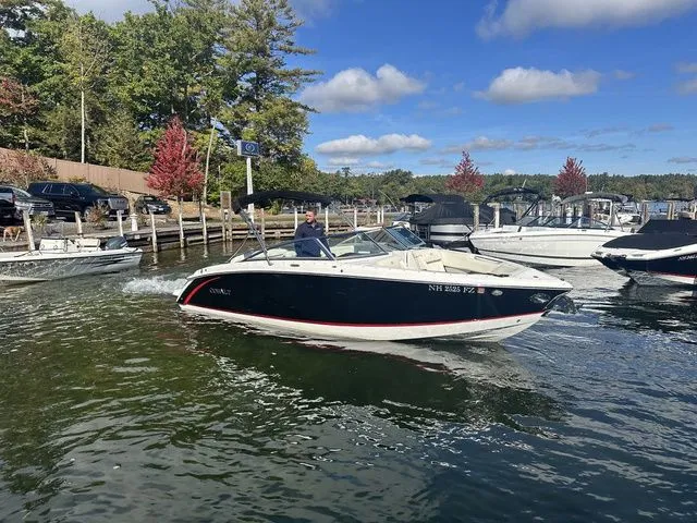 Slide: The Image of 2017 Cobalt R5 boat cruising on a scenic lake with trees and docks in the background. - 3