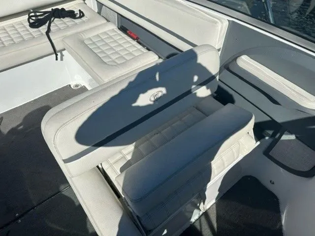 Slide: The Image of 2017 Cobalt R5 boat interior with white cushioned seating and shadow. - 7
