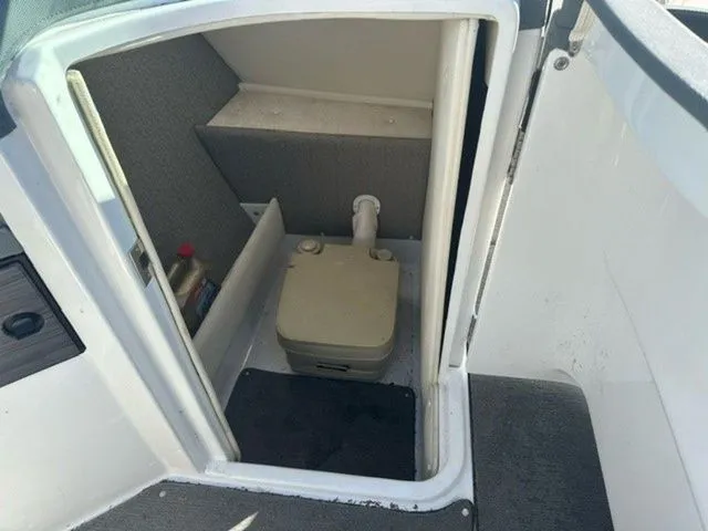 Slide: The Image of 2017 Cobalt R5 boat interior with compact portable toilet. - 8