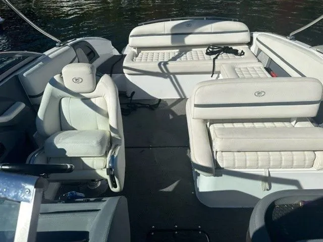 Slide: The Image of 2017 Cobalt R5 boat interior with white seating and open deck on water. - 9