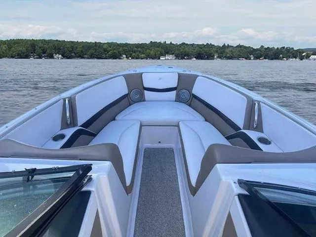 Slide: The Image of 2015 Four Winns H230 boat interior with white seating on a lake. - 10