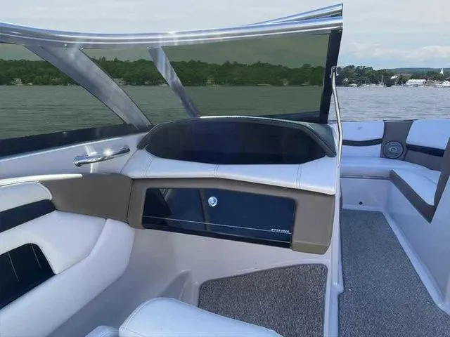 Slide: The Image of 2015 Four Winns H230 boat interior with sleek design and lake view. - 11