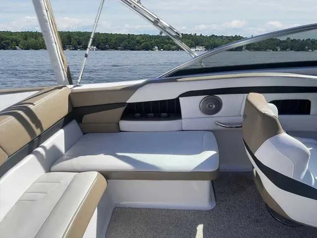 Slide: The Image of Interior of a 2015 Four Winns H230 boat with beige and white seating. - 15