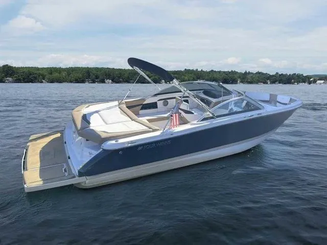 Slide: The Image of 2015 Four Winns H230 boat on a lake, featuring sleek design and spacious seating. - 6