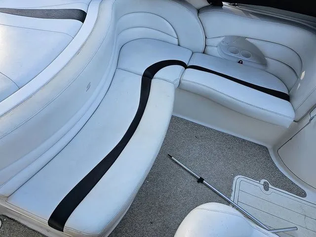 Slide: The Image of Interior seating of a 2004 Sylvan 2080 I/O boat with white upholstery and black accents. - 3