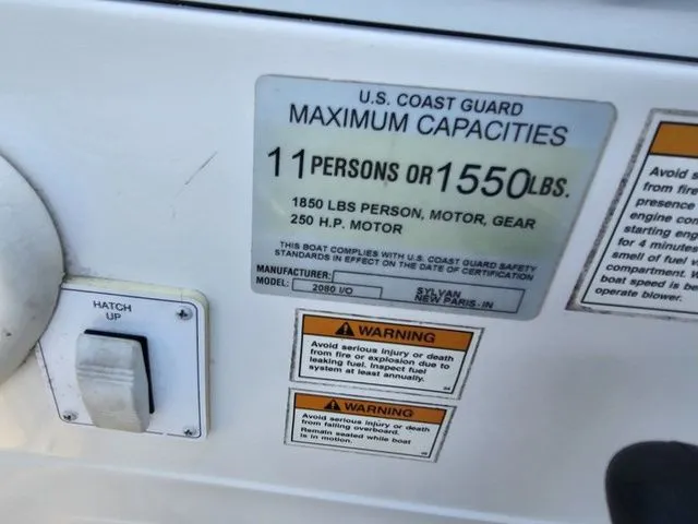 Slide: The Image of 2004 Sylvan 2080 I/O boat capacity label, 11 persons or 1550 lbs, safety warnings visible. - 5