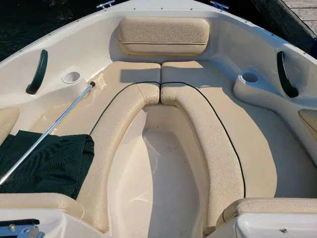 Slide: The Image of Interior of a 2000 Sea Ray 185BR boat with beige seating and cup holders. - 10