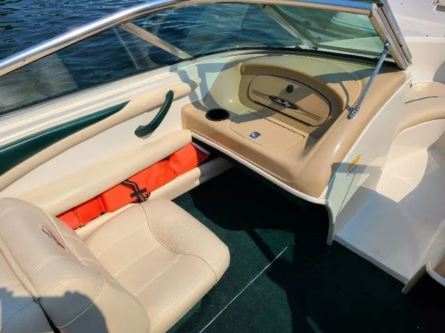 Slide: The Image of Interior of a 2000 Sea Ray 185BR boat with beige seating and orange life jackets. - 11