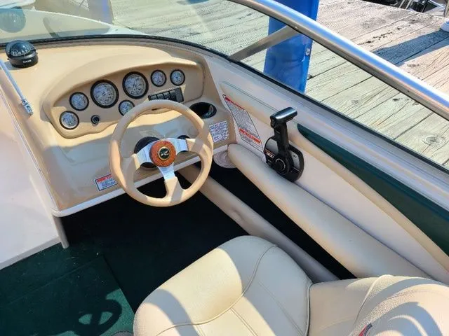 Slide: The Image of Interior view of a 2000 Sea Ray 185BR boat dashboard with steering wheel and controls. - 5