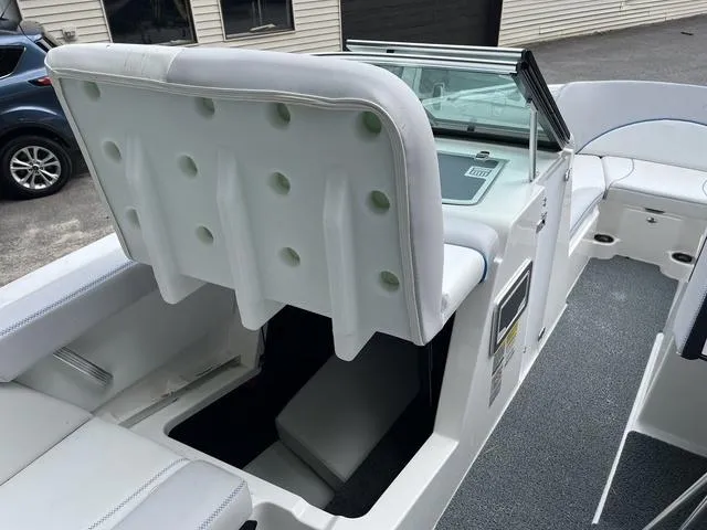 Slide: The Image of 2021 MasterCraft XT22 boat interior with white seating and storage compartment. - 17