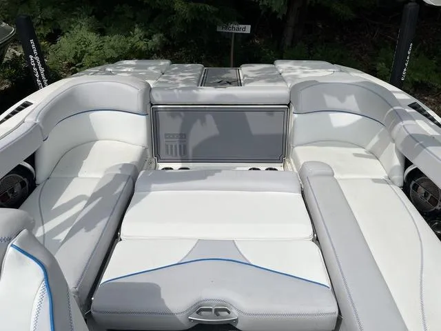 Slide: The Image of 2021 MasterCraft XT22 boat interior with white seating and blue accents. - 19