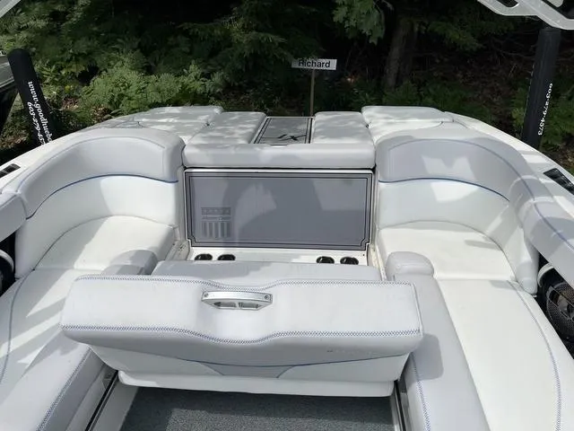 Slide: The Image of 2021 MasterCraft XT22 boat interior with white seating and cup holders. - 20