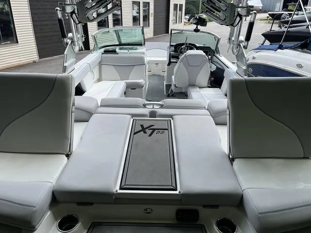 Slide: The Image of 2021 MasterCraft XT22 boat interior with sleek seating and modern design. - 26
