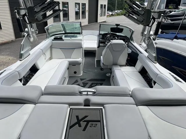 Slide: The Image of 2021 MasterCraft XT22 boat interior with sleek seating and modern dashboard design. - 8