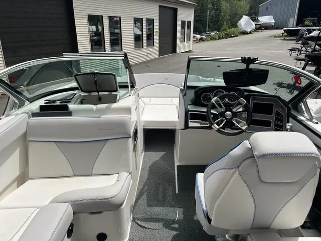 Slide: The Image of 2021 MasterCraft XT22 boat interior with white seating and modern dashboard. - 9