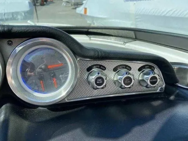 Slide: The Image of Dashboard controls of a 2014 MasterCraft X30 boat with gauges and switches. - 13