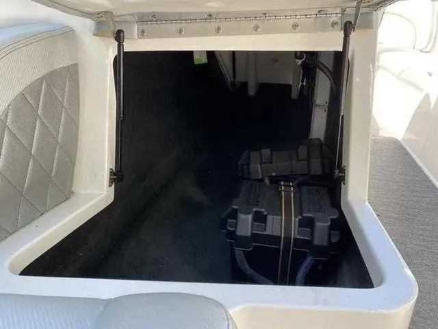 Slide: The Image of 2014 MasterCraft X30 storage compartment with battery box, open lid, and interior view. - 14