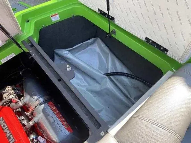 Slide: The Image of 2014 MasterCraft X30 boat engine compartment with green exterior and visible engine components. - 15
