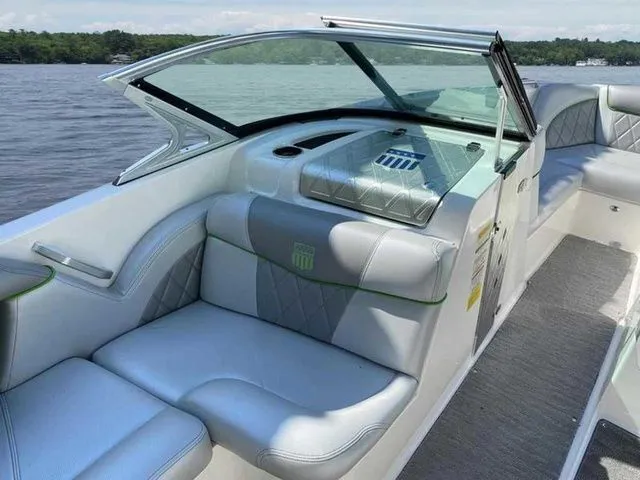Slide: The Image of 2014 MasterCraft X30 boat interior with white seating and lake view. - 18