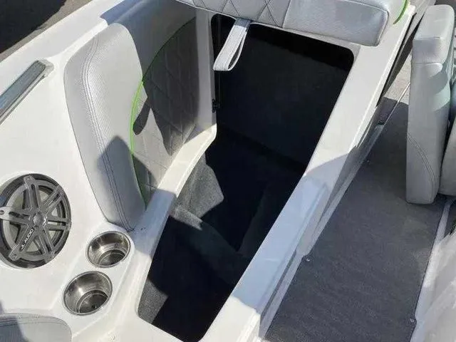 Slide: The Image of 2014 MasterCraft X30 boat interior with speaker, cup holders, and seating area. - 19