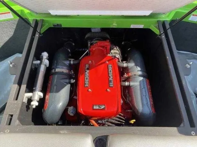 Slide: The Image of 2014 MasterCraft X30 boat engine, featuring a powerful Ilmor V8, in a vibrant green compartment. - 28
