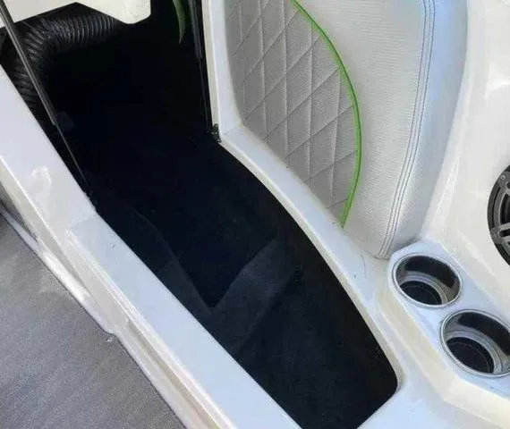 Slide: The Image of 2014 MasterCraft X30 interior with quilted seat, cup holders, and black flooring. - 29