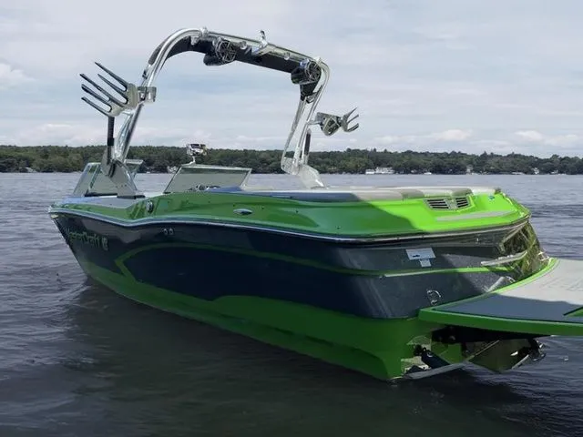 Slide: The Image of 2014 MasterCraft X30 boat in vibrant green on a calm lake. - 3