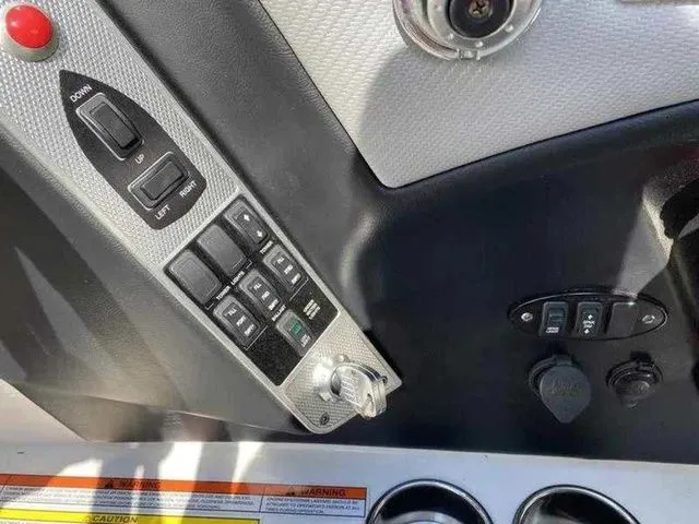 Slide: The Image of Control panel of a 2014 MasterCraft X30 boat with switches and ignition. - 30